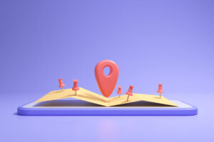 An open book sitting on a purple background. Small red GPS location markers litter the pages with a larger one in the center.