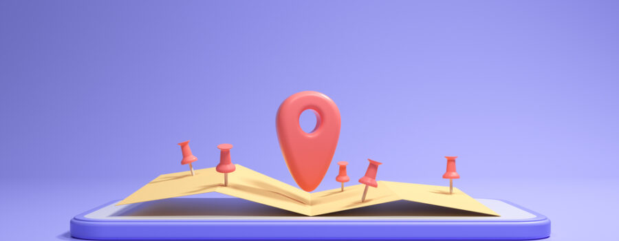 An open book sitting on a purple background. Small red GPS location markers litter the pages with a larger one in the center.